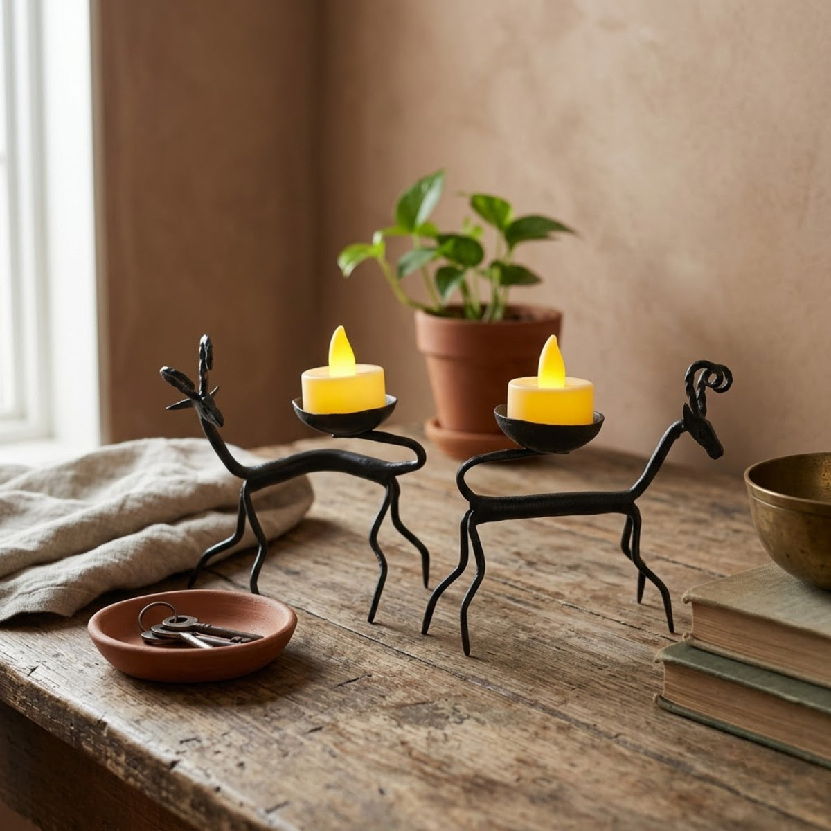 handcrafted bastar wrought iron spiral-horned antelope candle holders (pair)