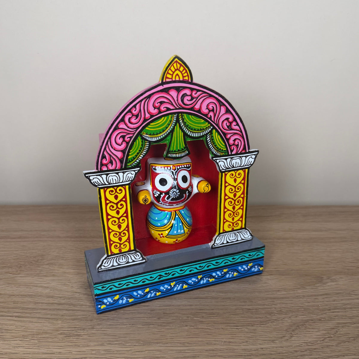 hand-painted wooden lord jagannath shrine with pink arch – traditional odisha pattachitra art